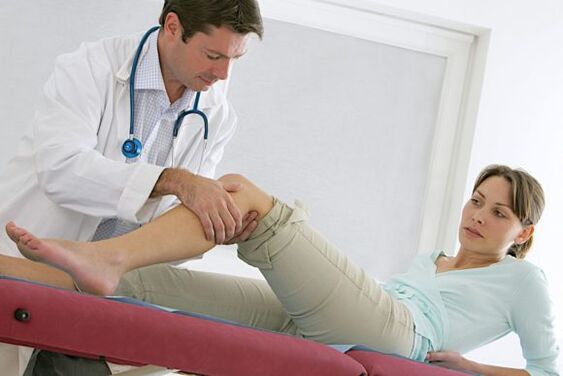 the doctor examines the legs after the operation for varicose veins